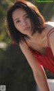 A woman in a red dress posing for a picture.