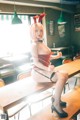 A woman sitting on top of a wooden table.
