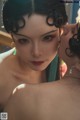 A woman is kissing another woman in front of a mirror.