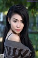 A woman with long black hair posing for a picture.